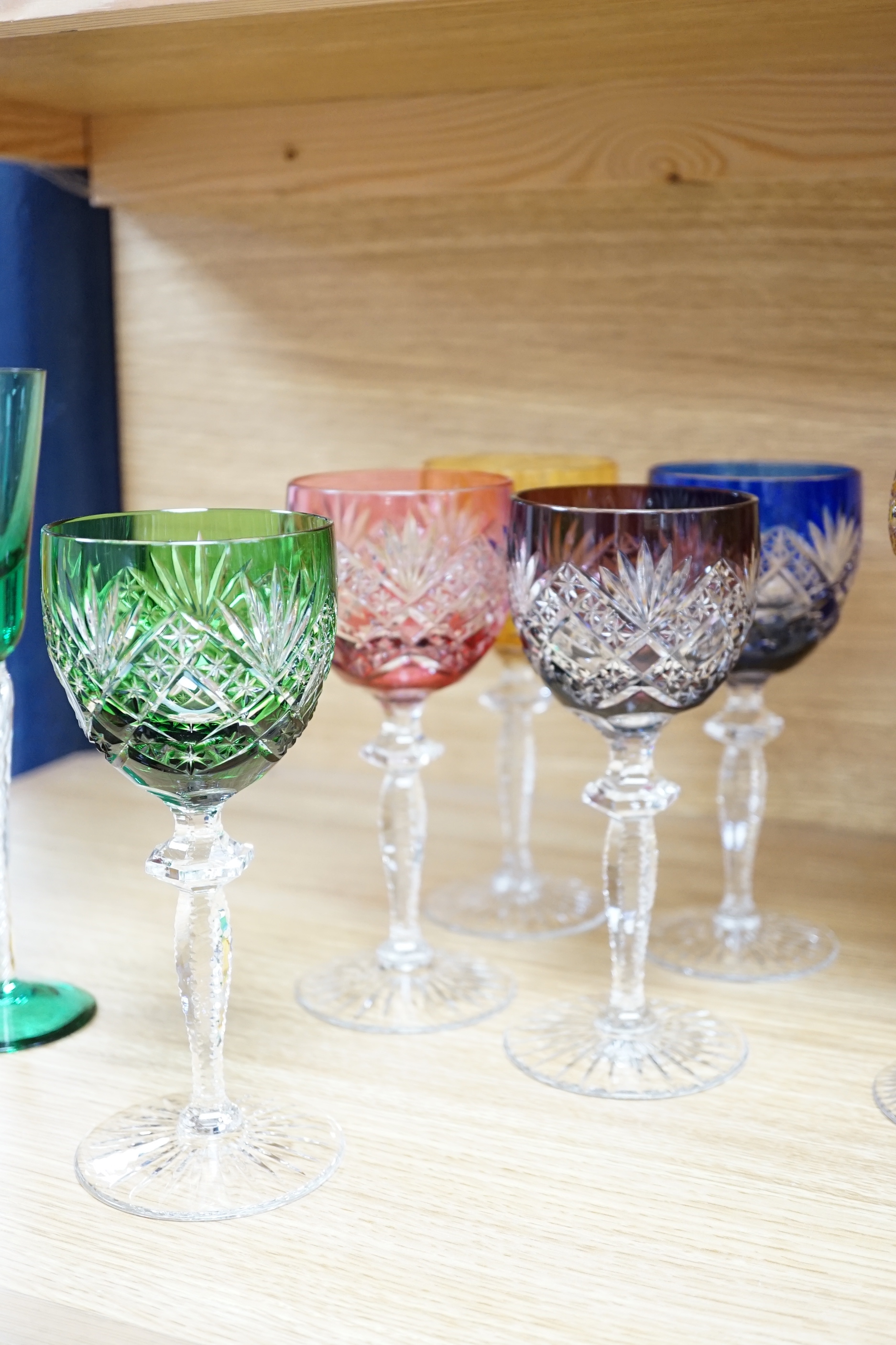 Two sets of six Harlequin colour flashed hock glasses and a set of four air twist glasses